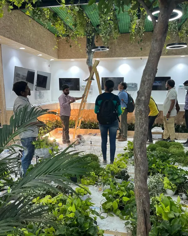 A behind-the-scenes look at our team setting up for a major event. We meticulously place each plant according to the design plan to create a full, immersive experience.