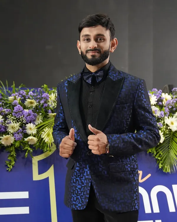 Sporting a custom-designed blue patterned tuxedo. This look is perfect for a formal awards ceremony or a stylish corporate gala, ensuring I complement the event's aesthetic.