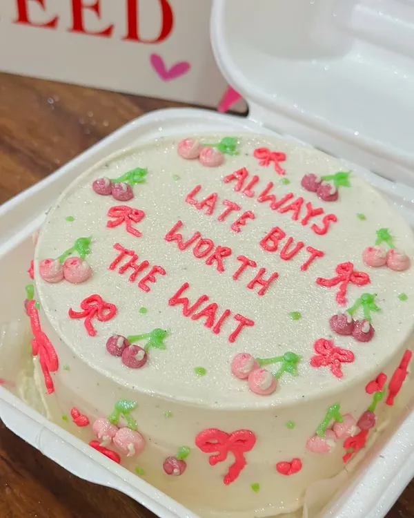 A cute and cheeky bento cake that’s perfect for your friend who is always fashionably late. This design features tiny hand-piped cherries and bows on our signature vanilla buttercream.