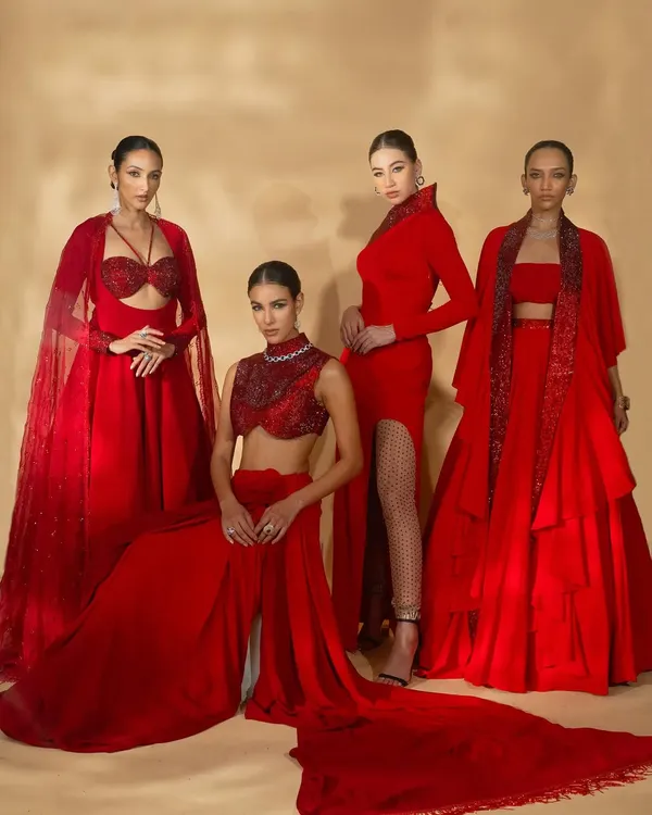 A group shot for Nikhil Thampi's 'Scarlet Edit', showcasing four models in coordinated red ensembles to highlight the collection's theme.