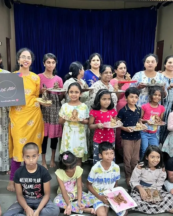 A wonderful group of adults and children proudly holding up the eco-friendly clay Ganesha idols they sculpted themselves. This workshop is a beautiful blend of tradition, creativity, and sustainability.