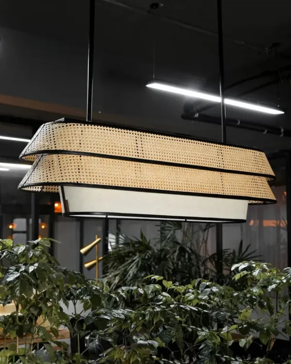 This two-tiered rattan chandelier makes a sophisticated statement, blending natural woven textures with a modern, linear form. It's an ideal lighting fixture for conference rooms, dining areas, or hotel lobbies, providing both ambient and direct light.