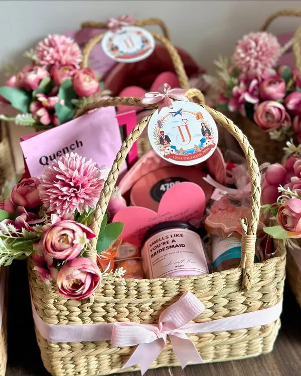 This is one of my all-time favorite bridesmaid proposal baskets! I fill these reusable wicker baskets with a beautiful floral arrangement and lots of pampering goodies to help you pop the question to your girls in the most special way.