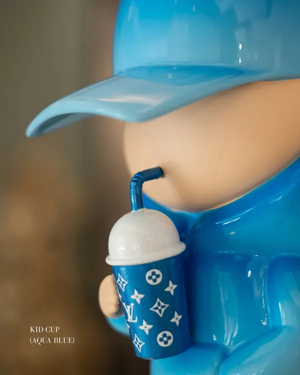 A close-up of the 'Kid Cup (Aqua Blue)' sculpture by the iconic duo Leo and Steph. We are thrilled to welcome their uber-cool creations to India for the first time, exclusively at our gallery.