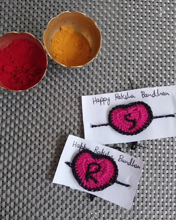 Custom initial rakhis for Raksha Bandhan. These heart-shaped rakhis with letters 'S' and 'R' are a personal way to celebrate the sibling bond.