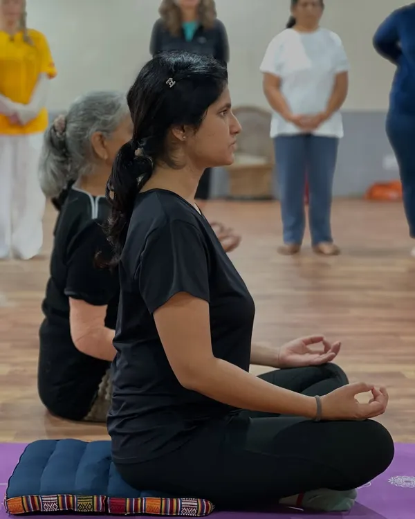 A student sits in a steady, comfortable posture for pranayama. An erect spine is essential for deep diaphragmatic breathing and the upward flow of energy.