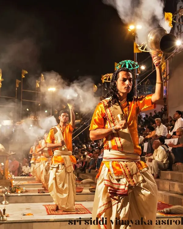 This is the sacred Ganga Aarti, a powerful ritual of light and sound offered to the divine. I guide you in understanding and connecting with the energy of such profound Vedic ceremonies, bringing their ancient blessings into your modern life.