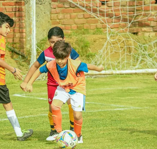 Intense action from the U8 Pride Cup as our young player shields the ball from two opponents. Learning to be strong on the ball starts early.