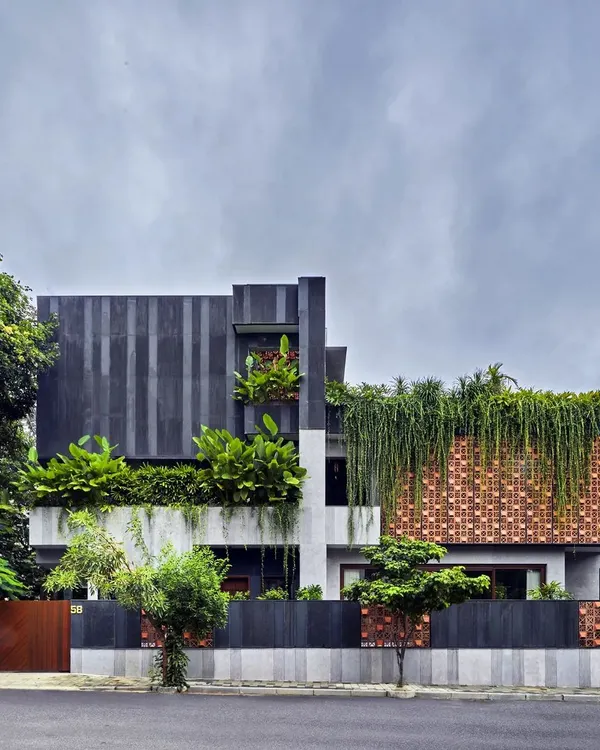 Project 58 is a home where the landscape takes over, making the architecture porous. Here, a facade of custom terracotta blocks and cascading greenery creates a living skin that breathes, connecting the home to its garden and the street.