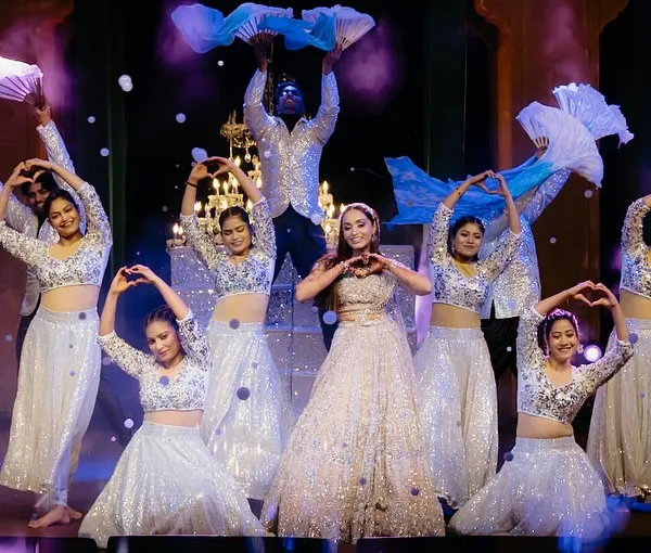 A beautiful formation for a bride and her squad. We used flowing fans and heart-hand gestures to create a visually soft and romantic performance, backed by professional dancers for a fuller look.