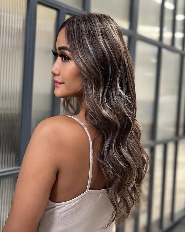 A look at my signature balayage technique, creating soft, flowing waves of color. This style adds dimension while maintaining a natural-looking root, perfect for a low maintenance yet high impact look.
