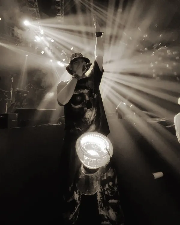 This is me in my element. A powerful moment captured on stage, with dramatic backlighting and my LED drum, commanding the attention of a massive audience. This is the iconic energy I bring.