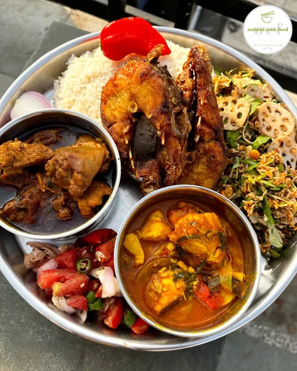 This is what a true Manipuri feast looks like. My non-veg thali is packed with variety, featuring fish curry, chicken curry, fried fish, a fresh lotus stem singju, and a simple tomato salad, all served with steamed rice.