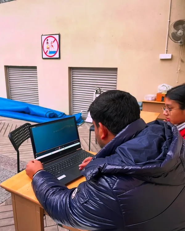 We believe in learning to walk before you run. Here, I'm using video playback to analyze a swimmer's technique. This focus on biomechanics is what separates good swimmers from great ones.