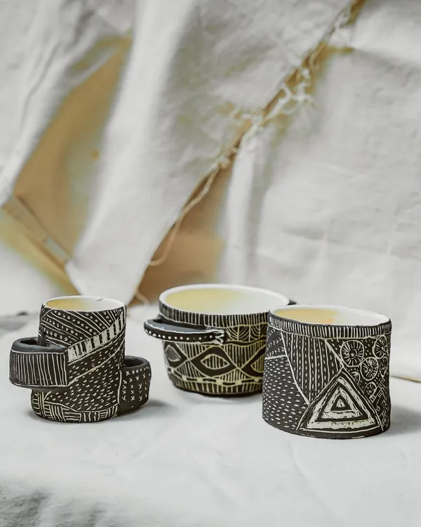 This trio of hand-built cups showcases the incredible detail and texture our Foundation course students learn to create. The intricate sgraffito patterns demonstrate a mastery of surface decoration and a unique artistic voice.