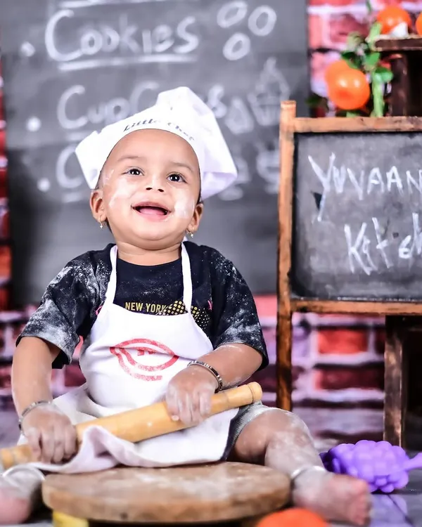 This little chef is all smiles and ready to get messy in his personalized kitchen. I love capturing these moments of pretend play, where their imagination truly shines.