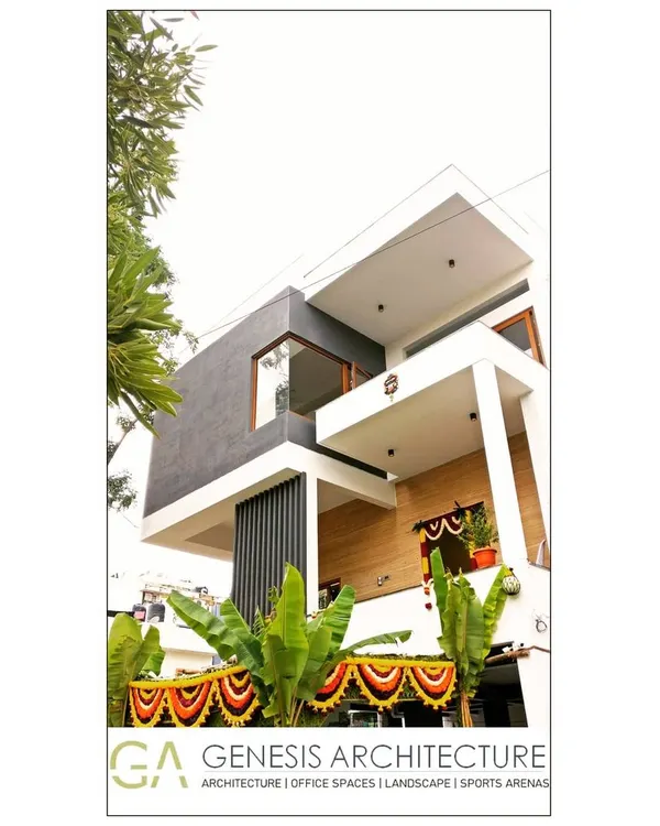 A modern villa in HSR Layout, Bangalore, ready for a housewarming. The design features strong geometric forms, cantilevered balconies, and a mix of textures that create a dynamic and welcoming facade for this family home.