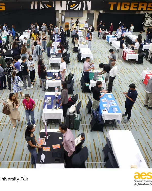 An overhead view of our bustling HS University Fair, showcasing the scale of the event. We ensure our students have ample opportunities to explore a wide range of international and domestic college options right here on campus.