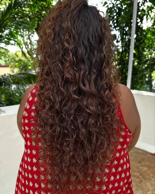 Once you embrace your curls, you'll never go back. Here's a look at a beautiful curly hair transformation, showing off the defined, healthy coils from the back.