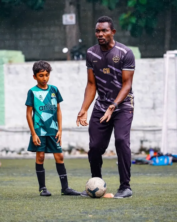 A coach provides one-on-one guidance to a young player. We believe in personalized attention to help every child master the fundamentals of ball control and technique.