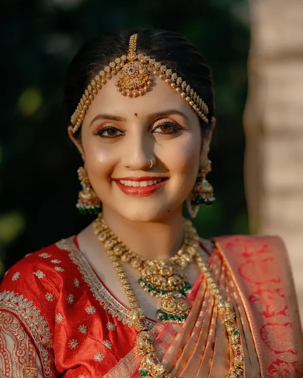 A radiant South Indian bride. I focused on creating a flawless, glowing base with defined eyes and a classic red lip to perfectly match her stunning Kanjeevaram saree and temple jewellery.