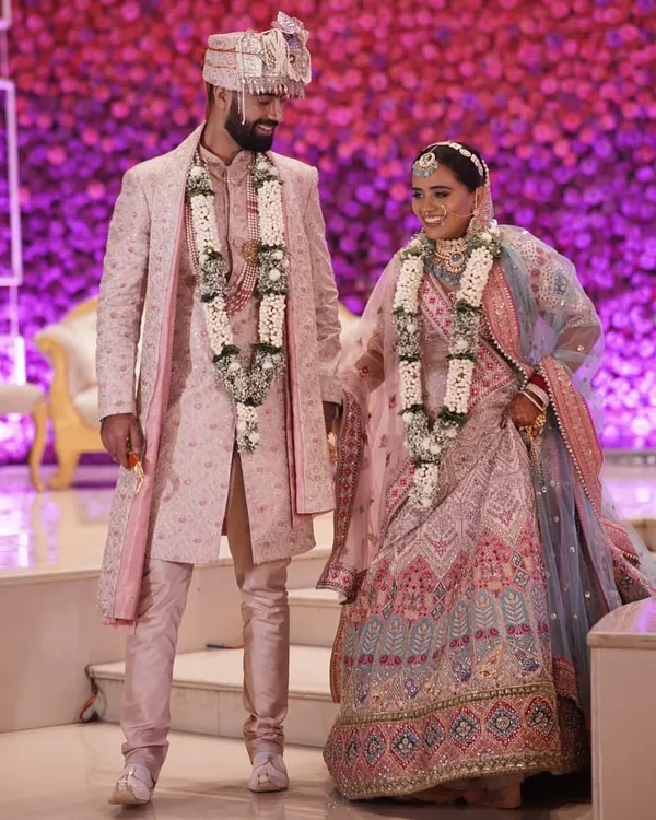 This is what a dream wedding looks like. We helped this wonderful couple find perfectly coordinated pastel pink outfits for their special day, from the groom's intricately embroidered sherwani to the bride's stunning lehenga.