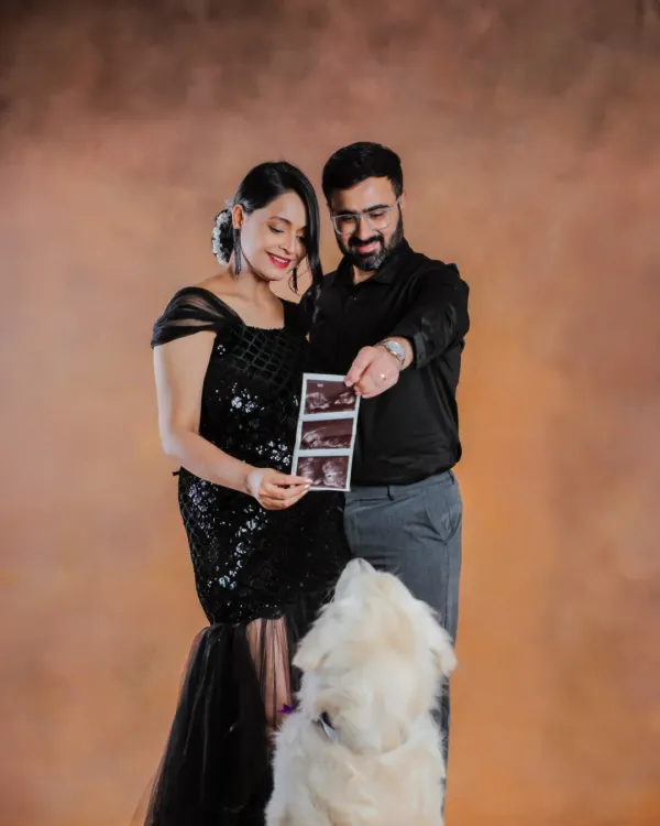 This little one is already so loved, and their furry big brother can't wait to meet them. We love including pets in your pregnancy announcement photos.