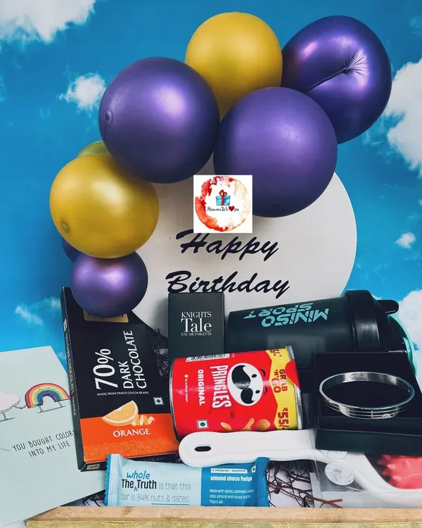 A stylish birthday hamper for him, featuring a mini balloon arrangement, a Miniso sport shaker, Pringles, dark chocolate, and a sleek bracelet.