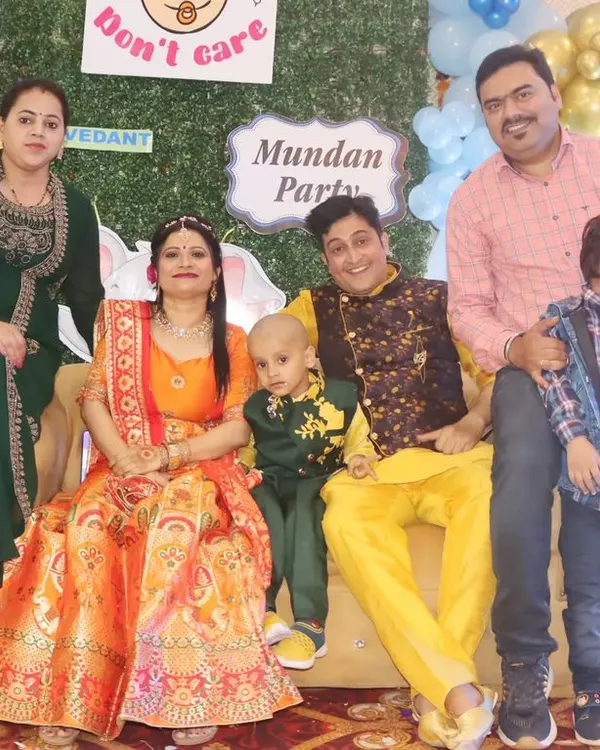 A full family group photo at a Mundan Party, capturing everyone dressed in festive attire to celebrate the special occasion.