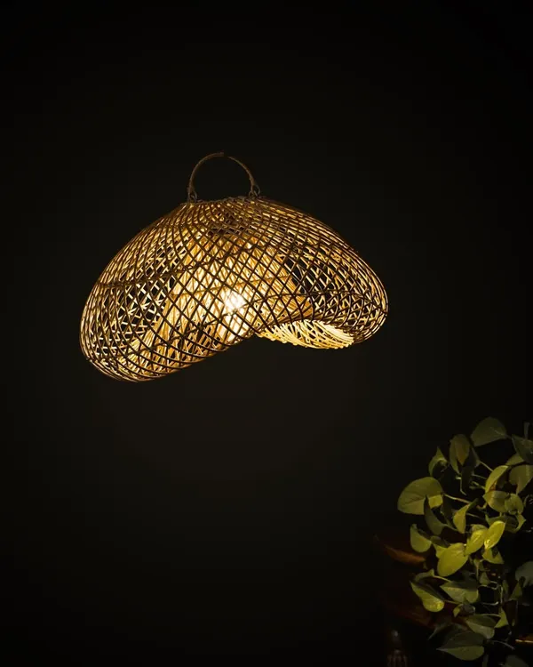 This lit sculptural lamp casts a mesmerizing glow, its light filtering through the complex, wavy weave. It is designed not just to illuminate a space, but to interact with it, creating moving patterns of light.