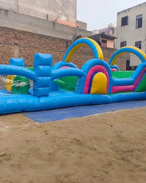 A long inflatable obstacle course designed for races and team-building events. It features a series of hurdles, tunnels, and climbing sections.