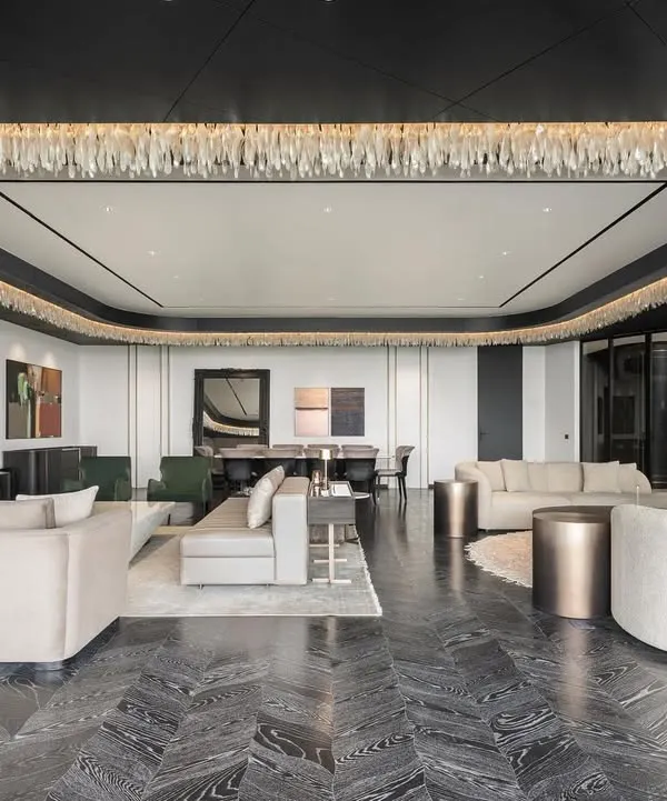 This expansive living room in a DLF Camellias residence showcases our ability to command scale with grace. We designed the space around a custom monochrome palette, with a show-stopping light installation of nearly 4000 glass shards that unifies the area, creating an atmosphere of monochrome elegance that is both grand and intimate.