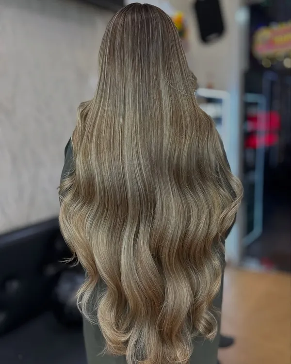 This is the ultimate hair goal. A stunning Icy Ash Blonde transformation showing off incredible length, health, and perfectly blended cool tones. This is the kind of expert-level color work I love to create.