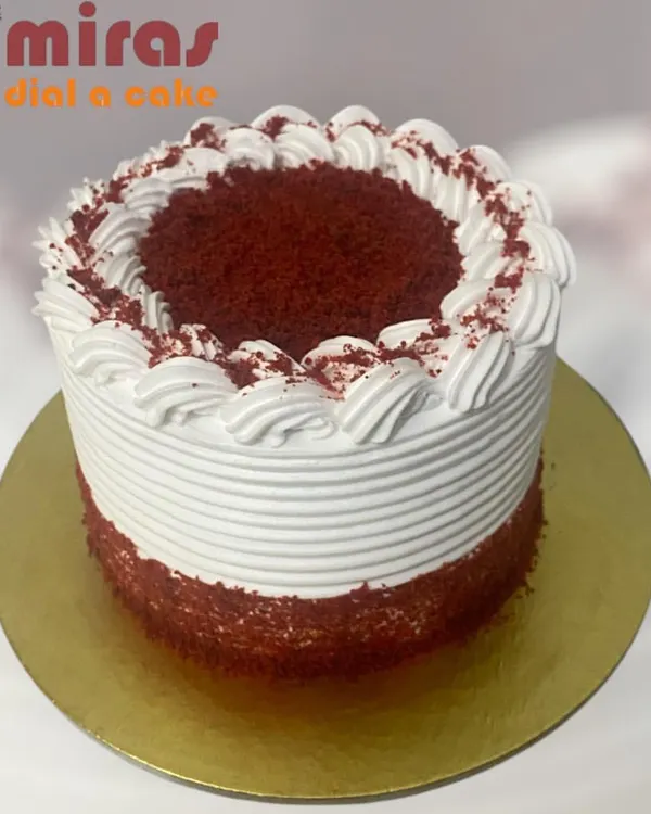 A classic Red Velvet cake, instantly recognizable by its deep red crumb and smooth cream cheese frosting. This simple yet elegant design is a timeless favorite for any celebration.