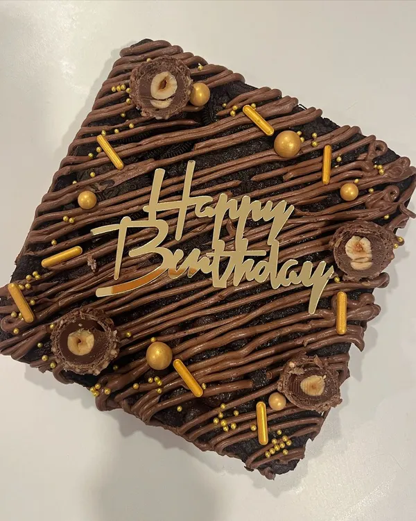 What's better than a slice of brownie? A whole brownie cake. This is a slab of my fudgiest eggless brownie, decorated with chocolate drizzle, sprinkles, and Ferrero Rocher.