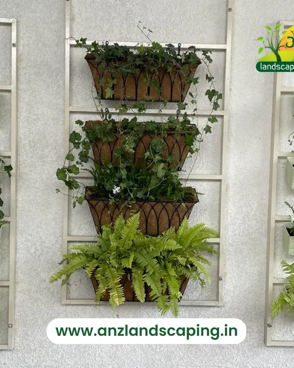 This stylish wall-mounted planter system uses a combination of hanging baskets and rectangular pots on a ladder-like frame. It's an elegant and versatile solution for adding greenery to a wall without a full installation.