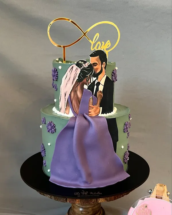 This two-tier cake features a hand-painted, edible illustration of the couple, making it a truly personal centerpiece for a wedding or engagement. The design combines my artistic skills with elegant fondant work to tell your unique love story.