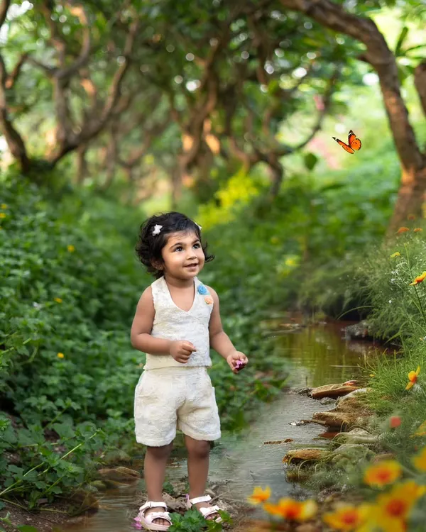 I believe in creating a little bit of magic. This outdoor toddler portrait captures that sense of wonder as she explores a beautiful, lush garden, complete with a butterfly that seems to have flown right into the frame.