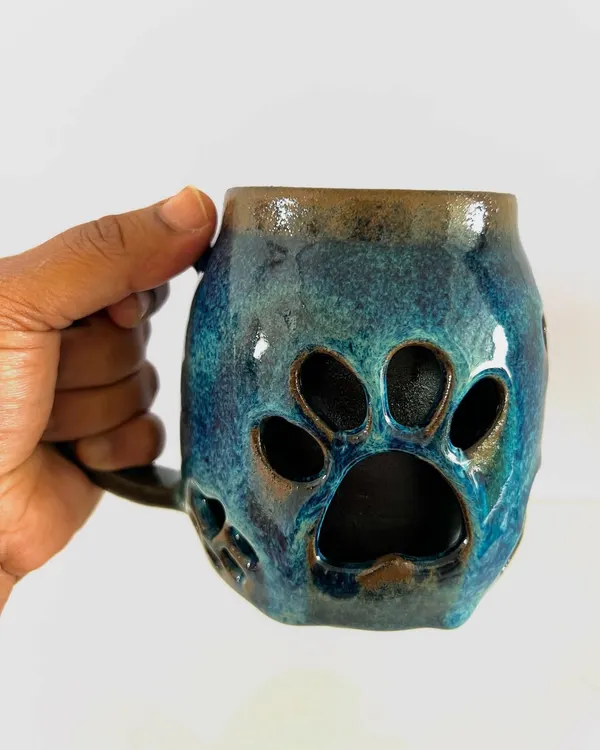 I love how this double-walled paw mug turned out. The paw prints are carved from the outer wall, making it a perfect gift for any dog lover. The deep blue glaze is just beautiful.