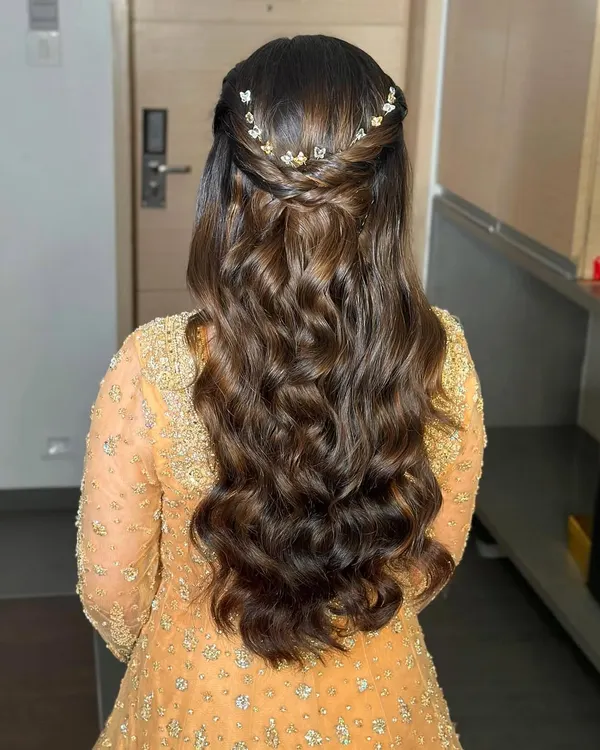 The back view of this soft glam look, showing the beautiful, bouncy waves. I added a delicate butterfly accessory to the half-up twist for a touch of whimsy.