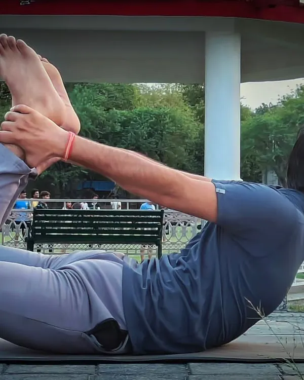 This is Dhanurasana, or Bow Pose, a powerful backbend for improving spinal elasticity. I guide my clients through this pose carefully, as it can be very beneficial for strengthening the back and managing issues like a slipped disc when done correctly.