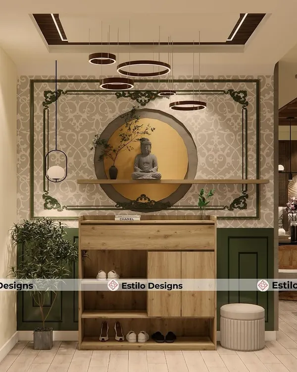 The foyer sets the tone for the entire home, and for this project, I created a serene entrance with a beautiful Buddha statue as the focal point. This space blends traditional Indian motifs with modern lighting and functional shoe storage.