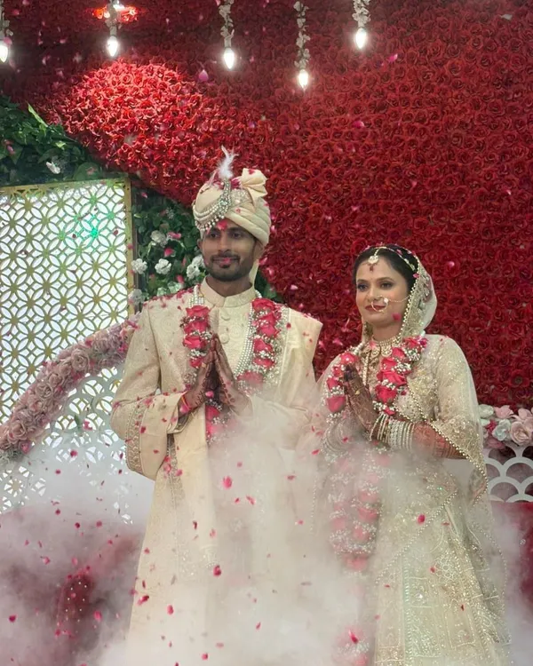 Arihant and Jagriti share a moment of joy during their wedding ceremony. Surrounded by a shower of petals, their union symbolizes the beautiful outcome when two hearts dedicated to seva and knowledge come together.