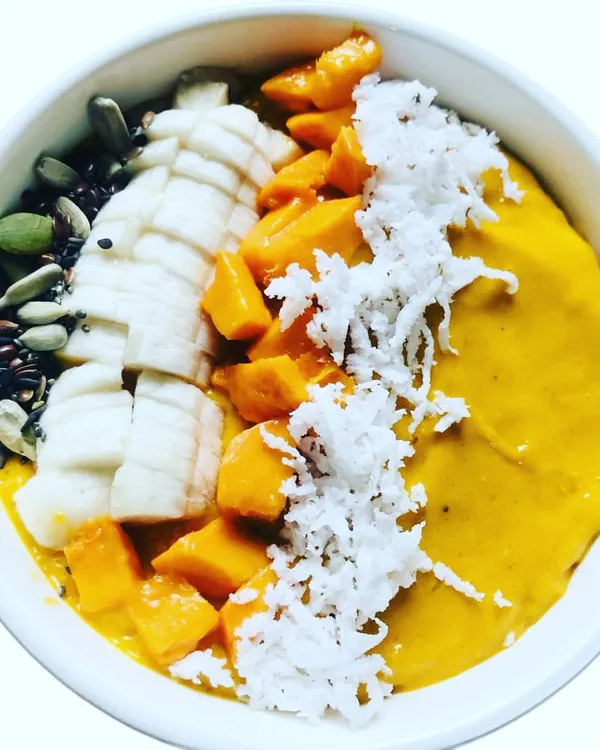 The king of fruits shines in my special Mango Smoothie. Made with mango, dates, and super seeds, and garnished with fresh banana and grated coconut, it's a taste of summer in a bowl.