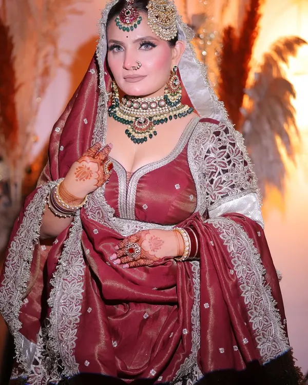 This is the bridal look I created for myself. A classic royal aesthetic with a deep maroon outfit, heavy kundan and emerald jewelry, and a focus on defined, captivating eyes.