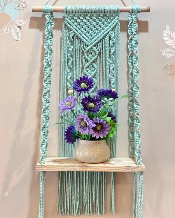 This is one of my most popular shelf designs. The beautiful mint green macrame panel provides a lovely backdrop for the light wood shelf, perfect for holding a vase or small decor items.