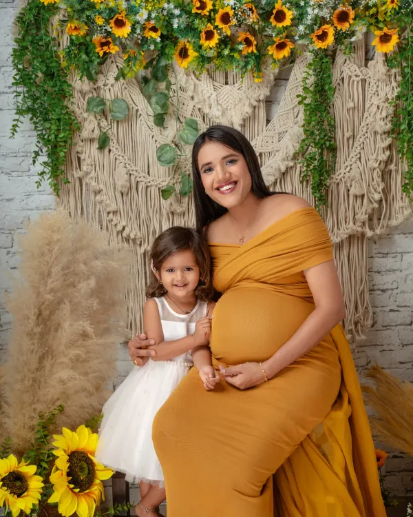 Welcoming a new baby is a family affair. This beautiful maternity portrait includes the older sibling, capturing her excitement about becoming a big sister.