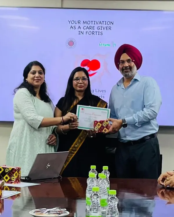 Receiving a certificate of appreciation for a session on caregiver motivation at Fortis. It's a reminder of the positive impact we can have on those who care for others.