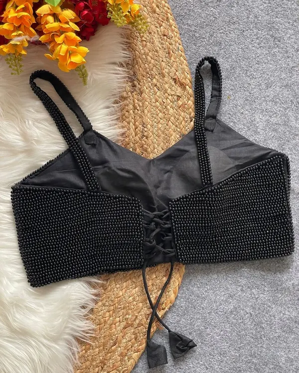The back view of my black pearl moti spaghetti blouse. This pure silk, padded blouse features a stylish back-open design with a lace-up tie for an adjustable fit.