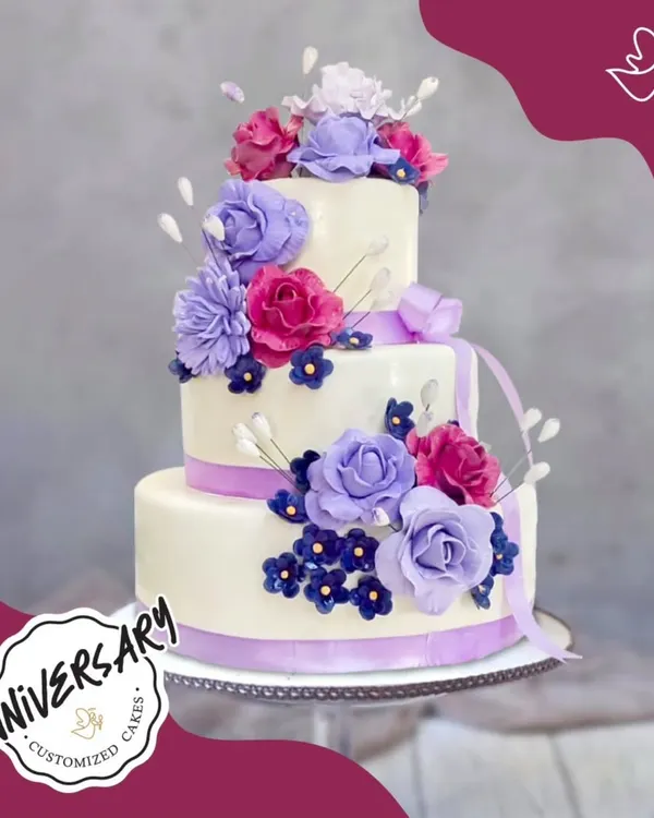 A grand three-tier floral cake for a special couple, Mr. and Mrs. Gaur, on their anniversary in GK2. The cascading purple and pink sugar flowers make this a truly showstopping celebration of their love.